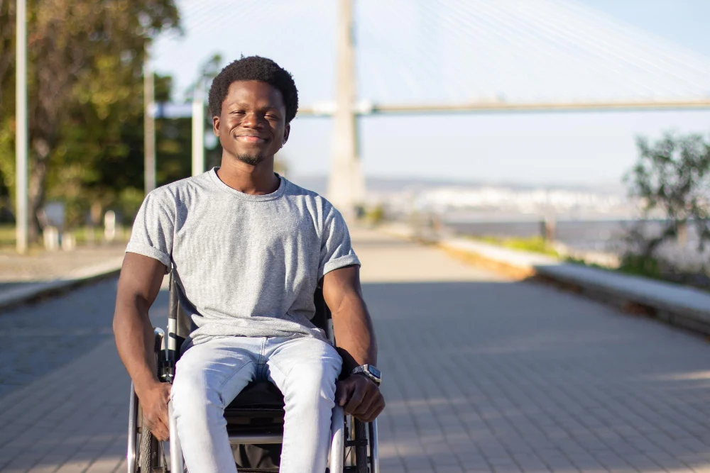 Man in wheelchair smiling outside Man in wheelchair smiling outside