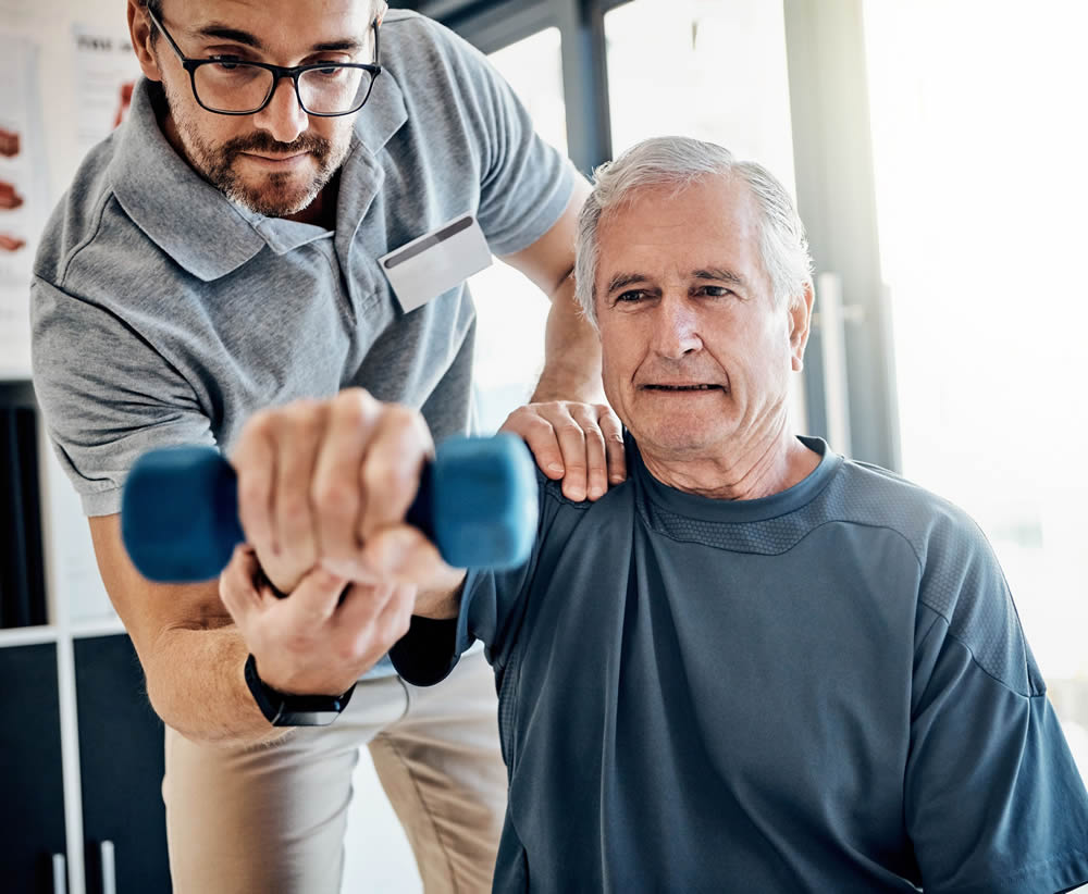 Assistant helping elderly man with exercise routine Health and Mobility Support