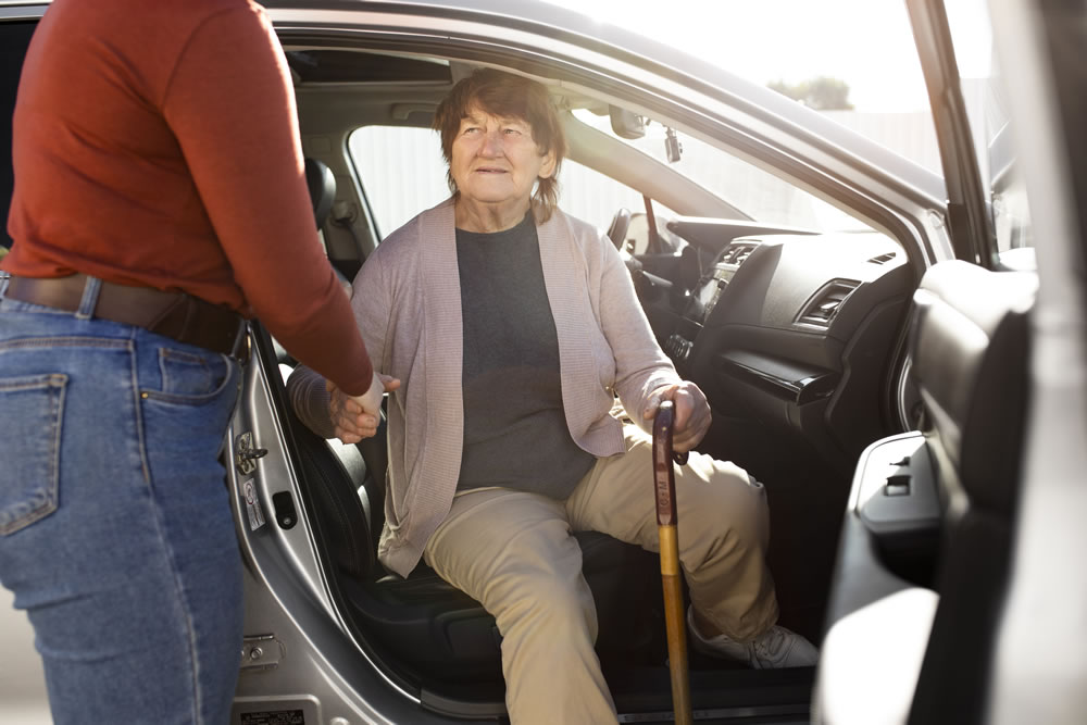 Assistant helping woman from car Travel and Transport