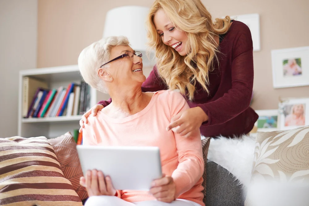 Family carer and older woman exploring respite care options at home