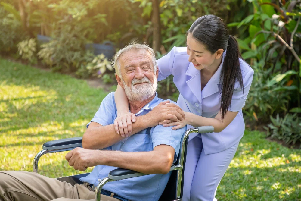Support worker assisting an older man at home