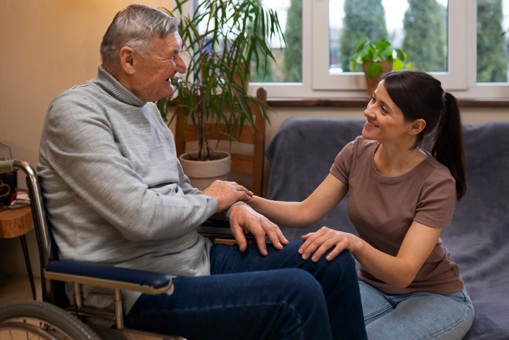 NDIS Home and Living Support Support worker assisting an older NDIS participant using a wheelchair at home