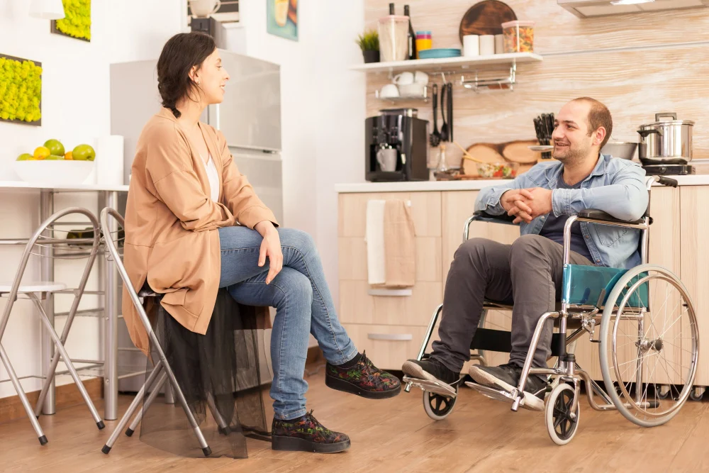 NDIS participant and support worker discussing respite care at home