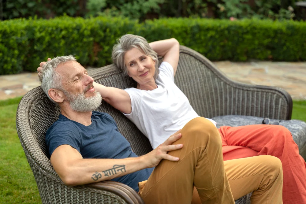 Older couple relaxing in their home garden