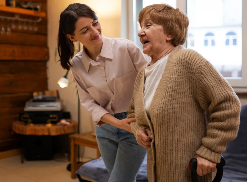 Older woman moving through home with support person