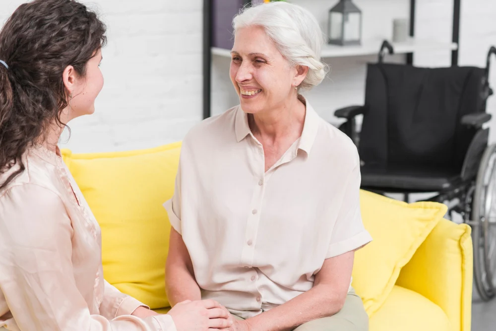 Older woman talking with support person at home