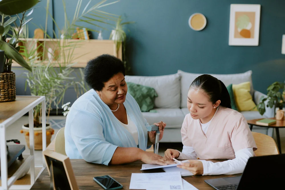 Participant and support worker reviewing NDIS plan at home