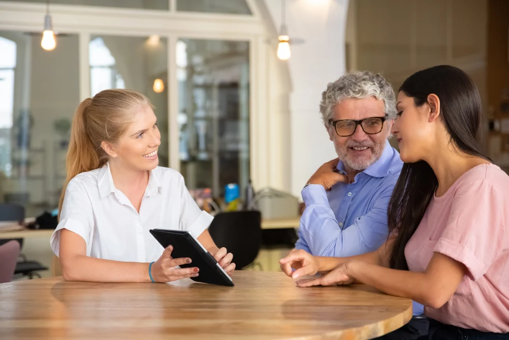 support provider discussing care options with older man and family member Support provider discussing care options with an older man and family member