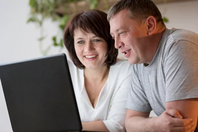 two family members researching support providers online