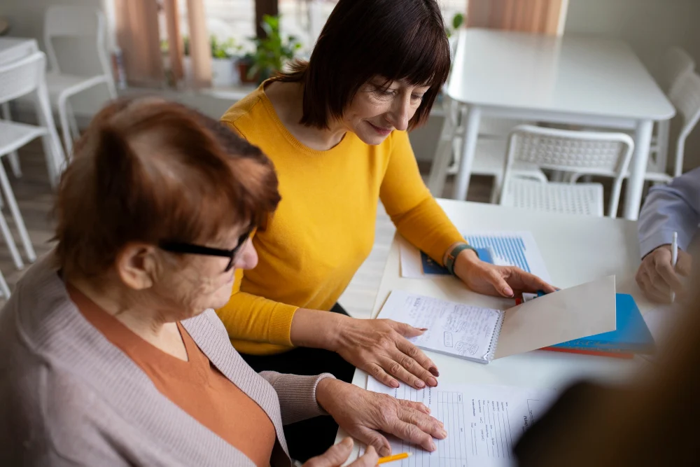 Two women at desk reading paperwork Two women at desk reading paperwork