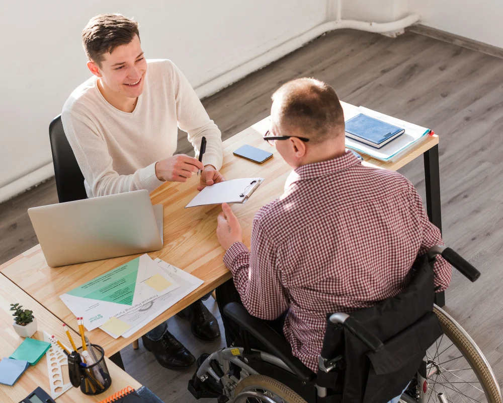 wheelchair user reviewing ndis service agreement with provider wheelchair user reviewing ndis service agreement with provider