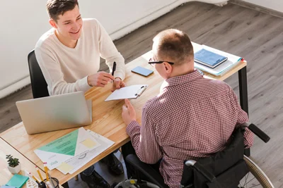 wheelchair user reviewing NDIS service agreement with provider