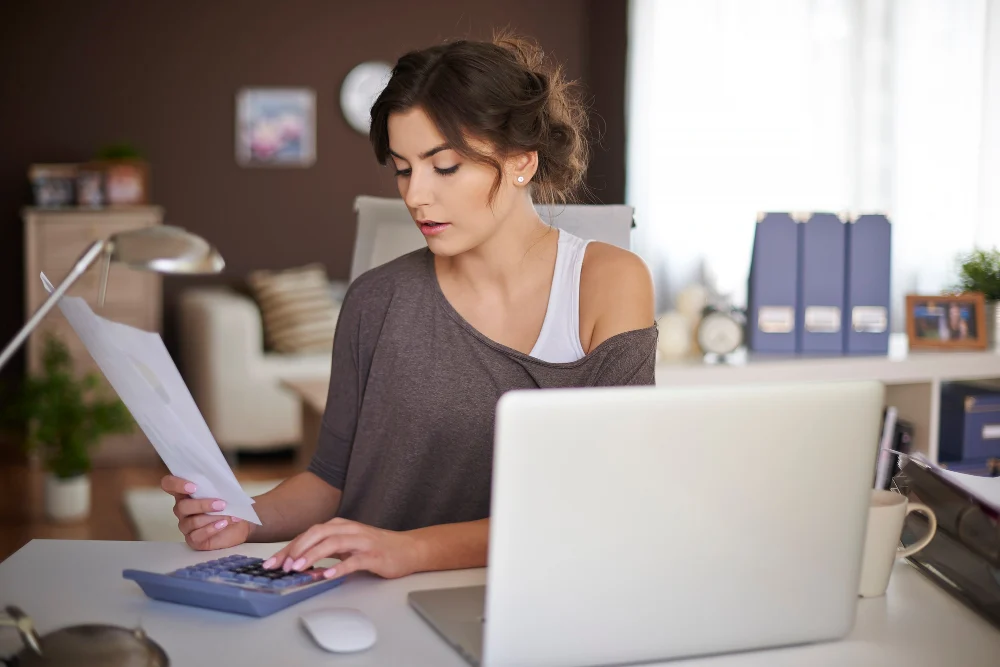 Woman checking NDIS invoice and service charges