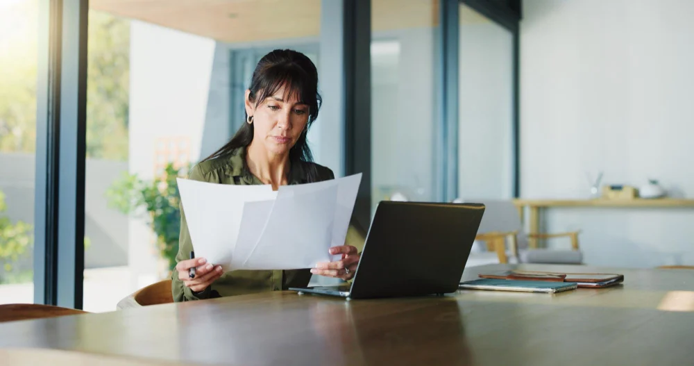 Woman reviewing a support service agreement at home Woman reviewing a support service agreement at home